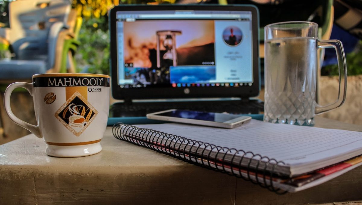 Photo by samer daboul: https://www.pexels.com/photo/white-smartphone-on-spiral-notebook-between-ceramic-mug-and-glass-beer-mug-near-black-computer-monitor-showing-hour-glass-1240050/